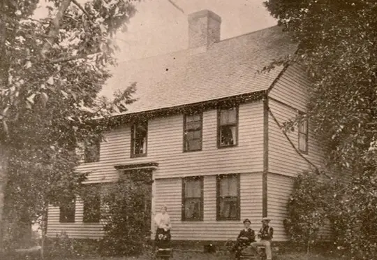 Lieut. John Hamlin's house in White Oak, Plainville, with family members seated on the front lawn